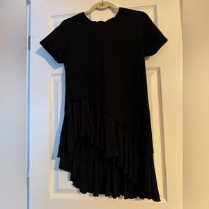 Black knit sweater with ruffles at the bottom